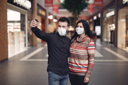 People in a masks stands on the streetの写真素材
