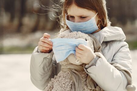 Little child walks outside in a maskの写真素材