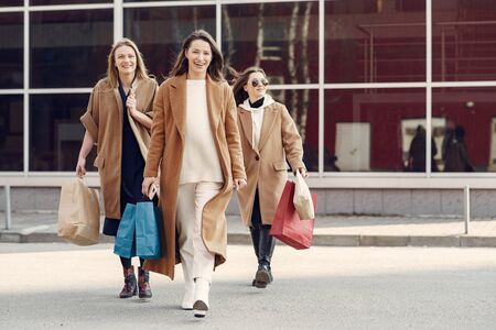 Woman walks outside with shopping bagsの写真素材