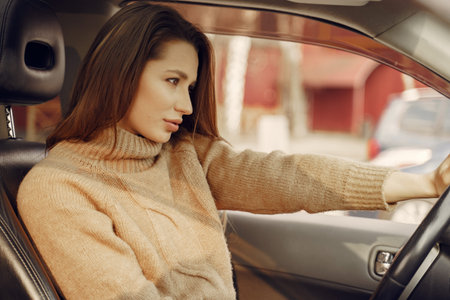 Elegant businesswoman sitting in a car