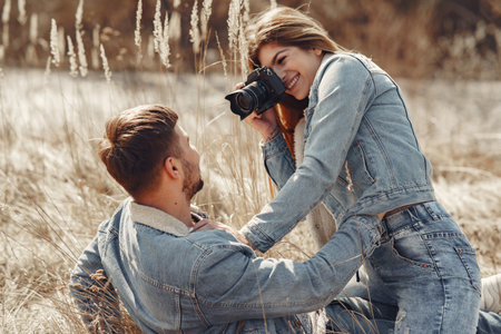 Cute couple in a jeans clothes in a spring field