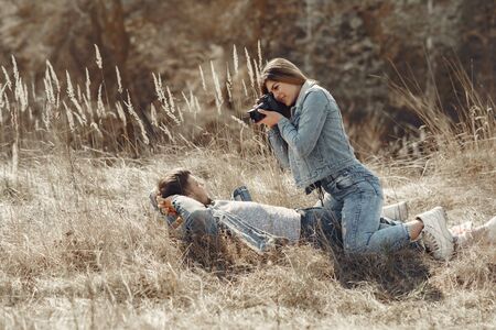 Cute couple in a jeans clothes in a spring fieldの写真素材
