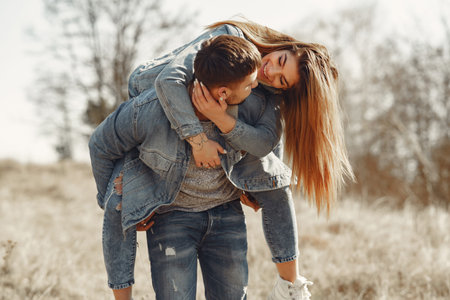 Woman in a jeans clothes. Couple in a spring forest.
