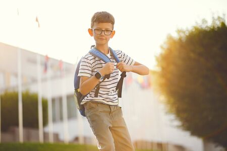 Schoolboy with a skate and backpackの写真素材