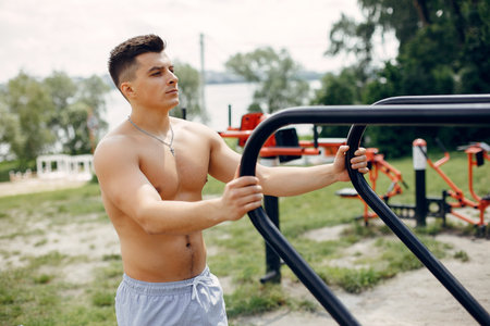 Sports man in a morning summer park