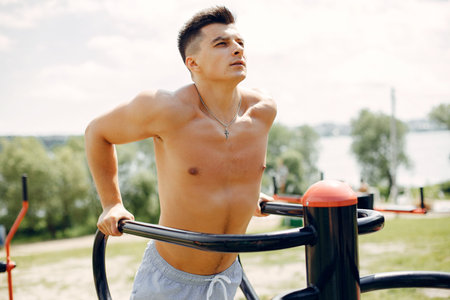 Sports man in a morning summer park
