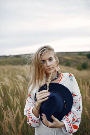 Beautiful elegant girl in a autumn wheat field