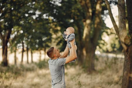 Cute family playing in a autumn fieldの写真素材