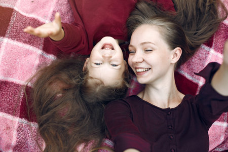 Mother with daughter playing in a summer parkの写真素材