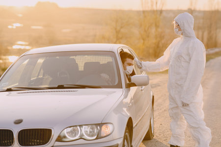 Person in a protective suit checks the temperature