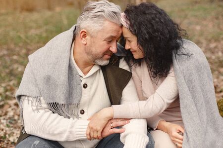 Elegant adult couple in a spring forestの写真素材