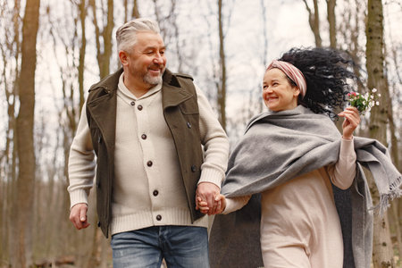 Elegant adult couple in a spring forest