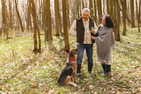 Elegant adult couple in a spring forestの写真素材