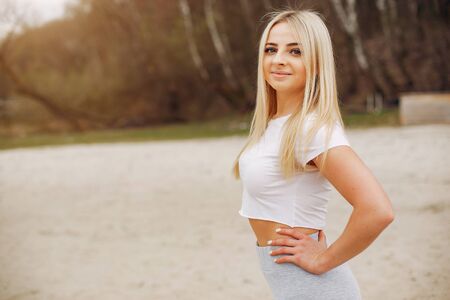 Sports girl in a morning summer parkの写真素材