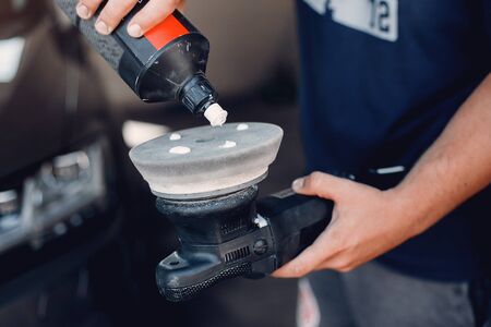 Man polish a car in a garageの写真素材