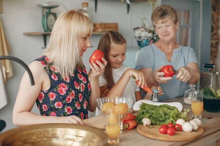 Beautiful family prepare food in a kitchenの写真素材