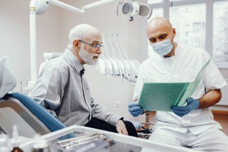 Old man sitting in the dentists officeの写真素材