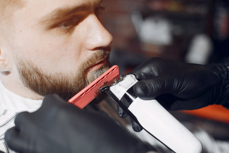 Stylish man sitting in a barbershopの写真素材