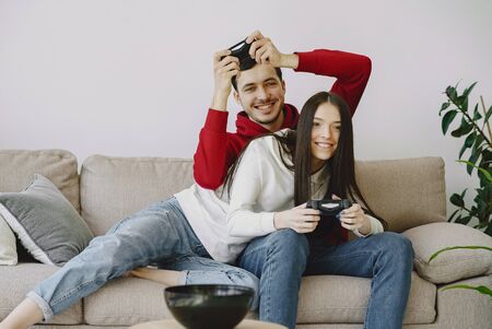 Couple at home playing in a video gamesの写真素材