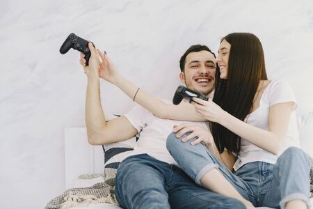 Couple at home playing in a video gamesの写真素材