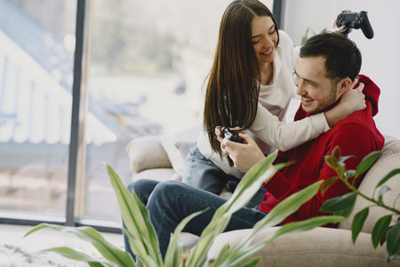 Couple at home playing in a video gamesの写真素材
