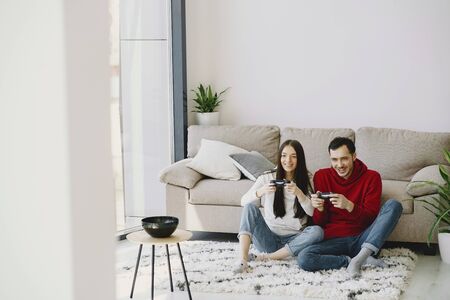 Couple at home playing in a video gamesの写真素材
