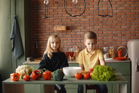 Children prepare salan in a kitchenの写真素材