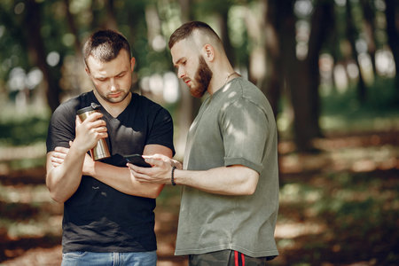 Two friends have a rest in a summer forest