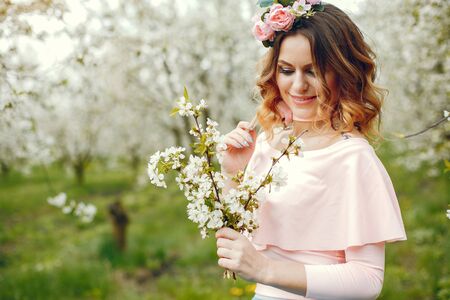 Elegant and stylish girl in a spring parkの写真素材