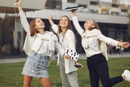 Young students on a student campus with a phoneの写真素材