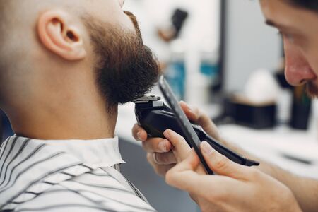 Stylish man sitting in a barbershopの写真素材