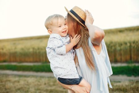 Mother with son playing in a summer fieldの写真素材