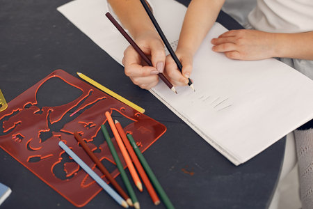 Tutor with litthe girl studying at home