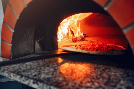 Chef in the kitchen prepares pizzaの写真素材