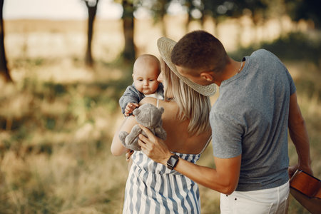Cute family playing in a autumn field