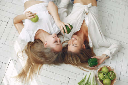 Healthy eating. Dieting and people concept. Blonde with a vegetable.の写真素材