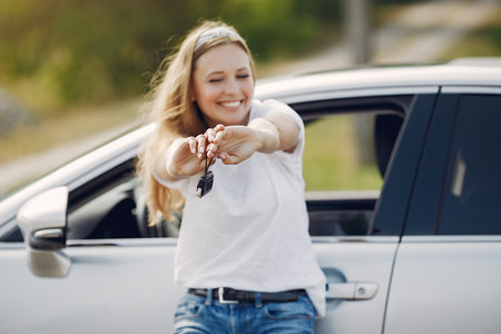 Elegant woman standing by the car