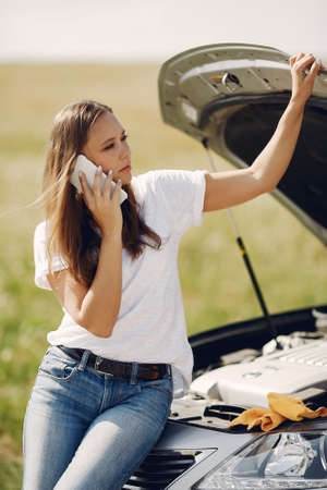 Woman near broken car call for helpの写真素材