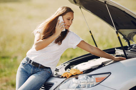 Woman near broken car call for helpの写真素材