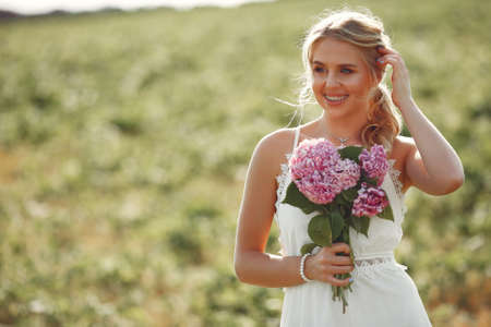 Beautiful elegant girl in a autumn fieldの写真素材