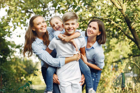 Mother with cute kids in a spring parkの写真素材