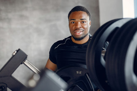 A handsome black man is engaged in a gym