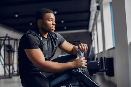 A handsome black man is engaged in a gym