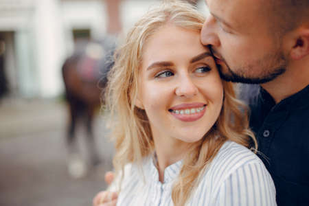 Cute loving couple with horse on ranchの写真素材
