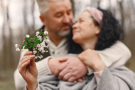 Elegant adult couple in a spring forestの写真素材
