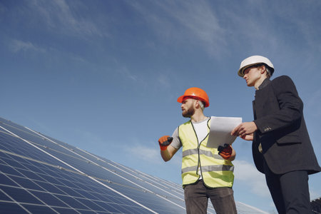 Foreman and businessman at solar energy station.
