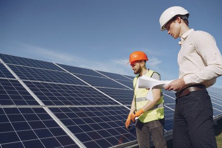 Foreman and businessman at solar energy station.
