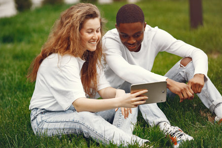 Interracial students has a fun and laughs cheerfully in park