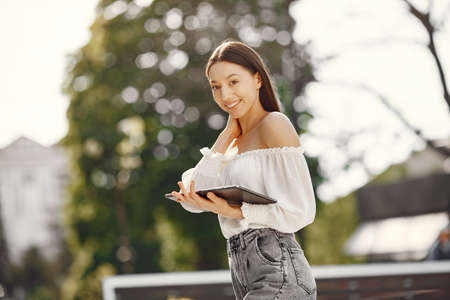 Students standing in a city with a tabletの写真素材