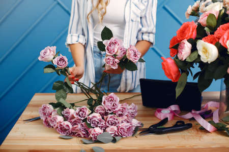 Frorist makes a beautiful bouquet in a studioの写真素材